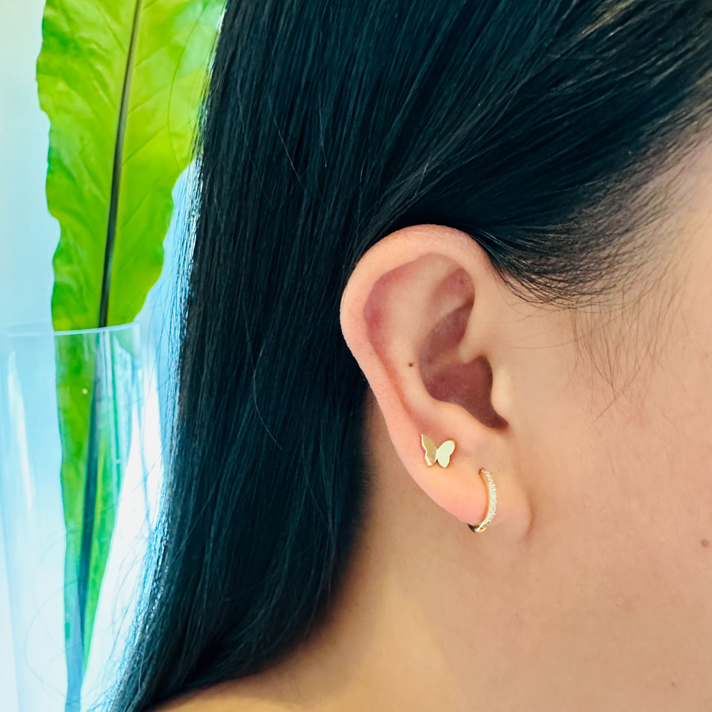 Pave Diamond Small Hoops 18k gold stacked on model ear – Foundry