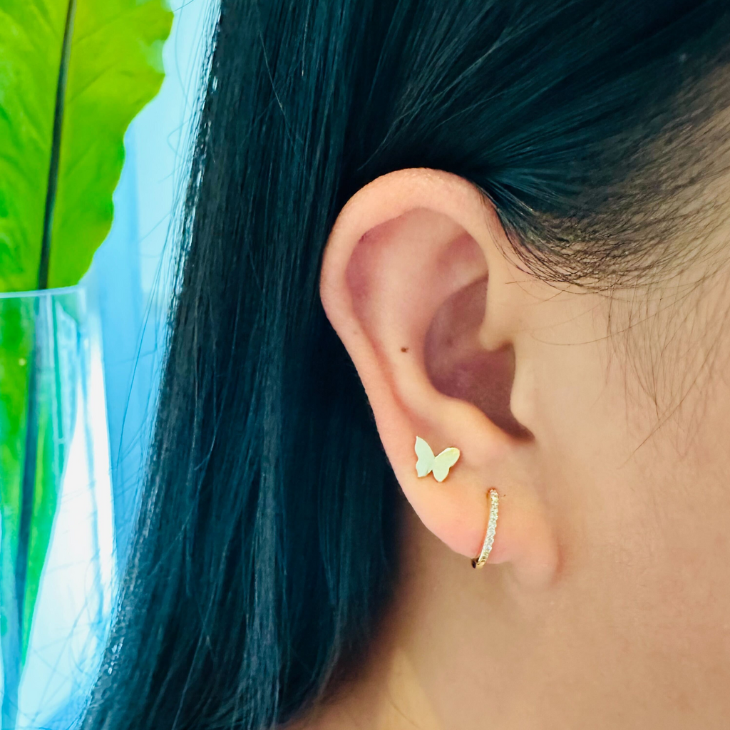 Pave Diamond Small Hoops 18k gold stacked on model ear – Foundry