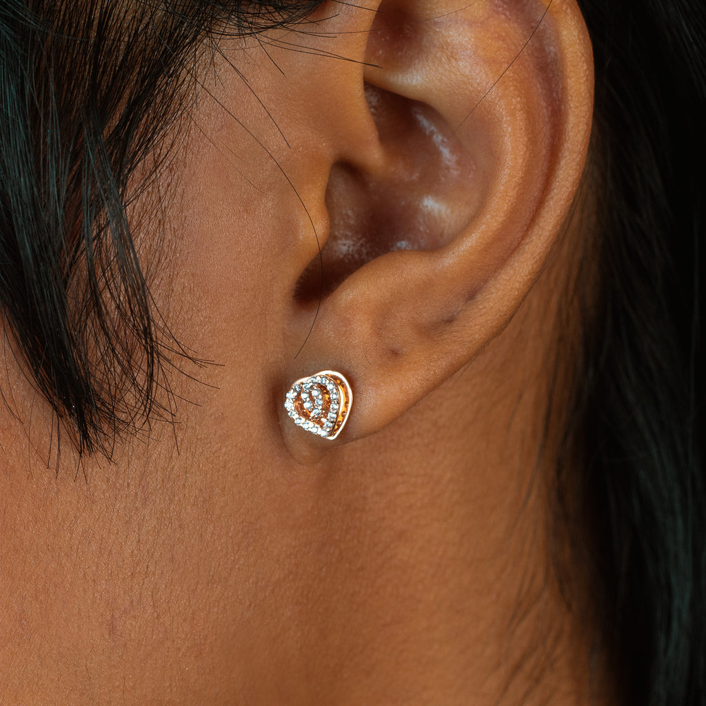 Pave Heart Loop Studs 18k rose gold stacked on model ear – Foundry
