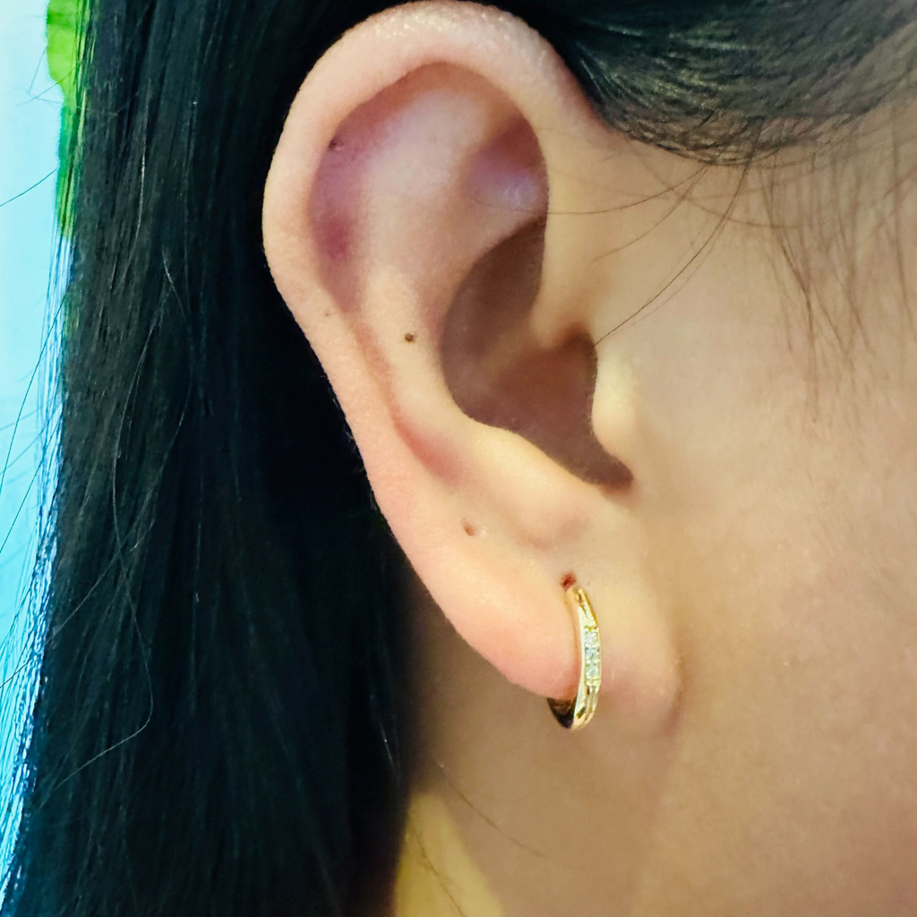 Pave Trio Diamond Hoops 18k gold stacked on model ears – Foundry