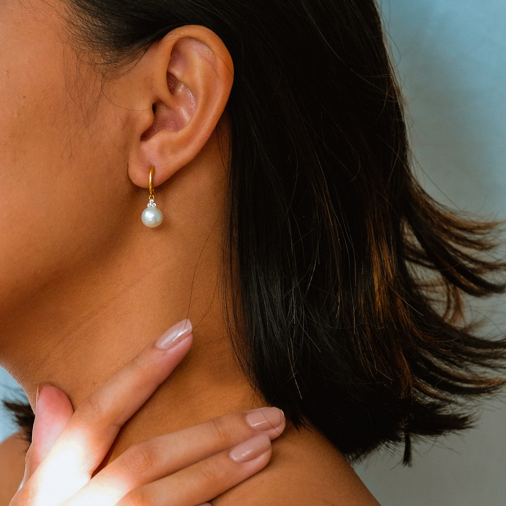 Pearl Drops 18k gold stacked on model ear – Foundry