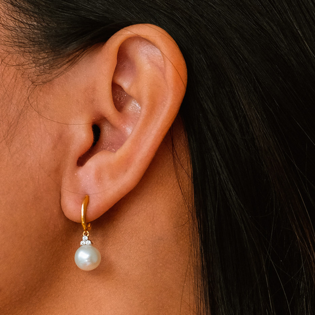 Pearl Drops 18k gold stacked on model ear – Foundry