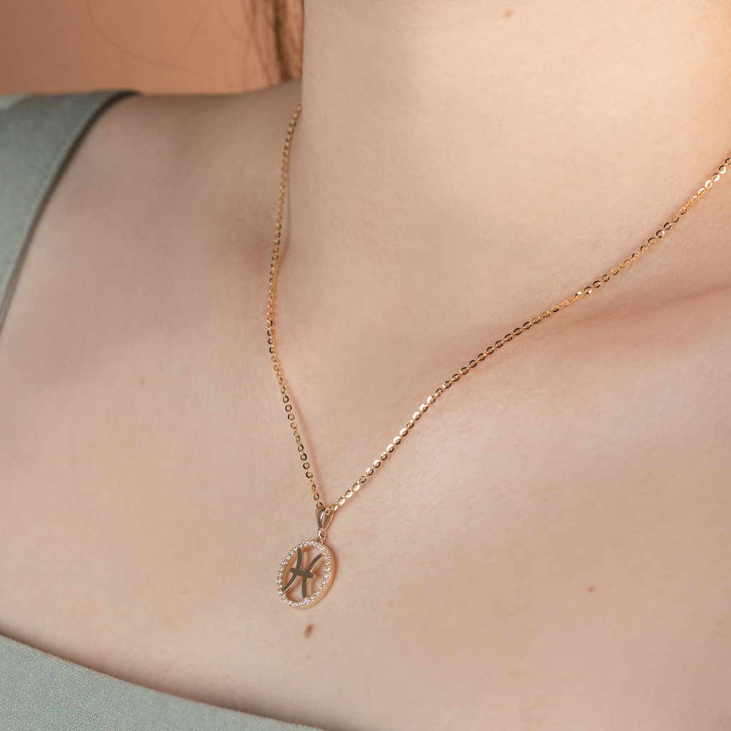 Pisces Pendant 14k gold stacked on model neck – Foundry