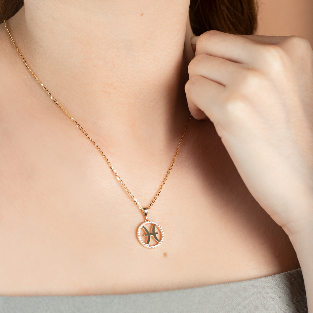 Pisces Pendant 14k gold stacked on model neck – Foundry