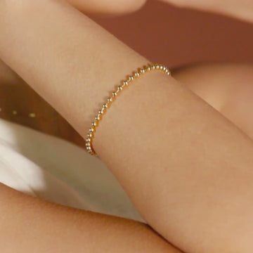 Bold Spheres Bracelet 14k gold stacked with bangles on model wrist, video – Foundry