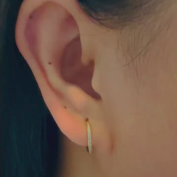 Channel Diamond Huggie Hoops 18k gold stacked on model ears, video – Foundry