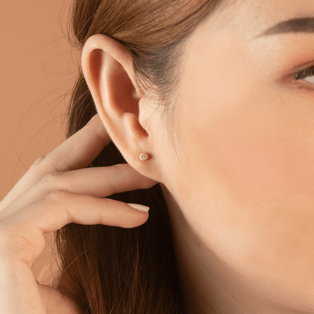 Round Diamond Mini Studs 14k gold stacked on model ears – Foundry