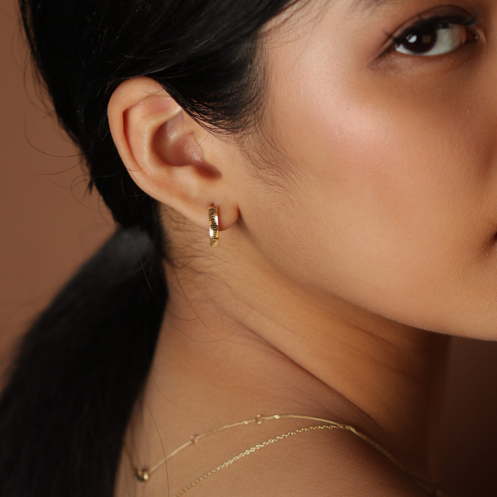 Scalloped Hoops 18k gold stacked on model ear – Foundry