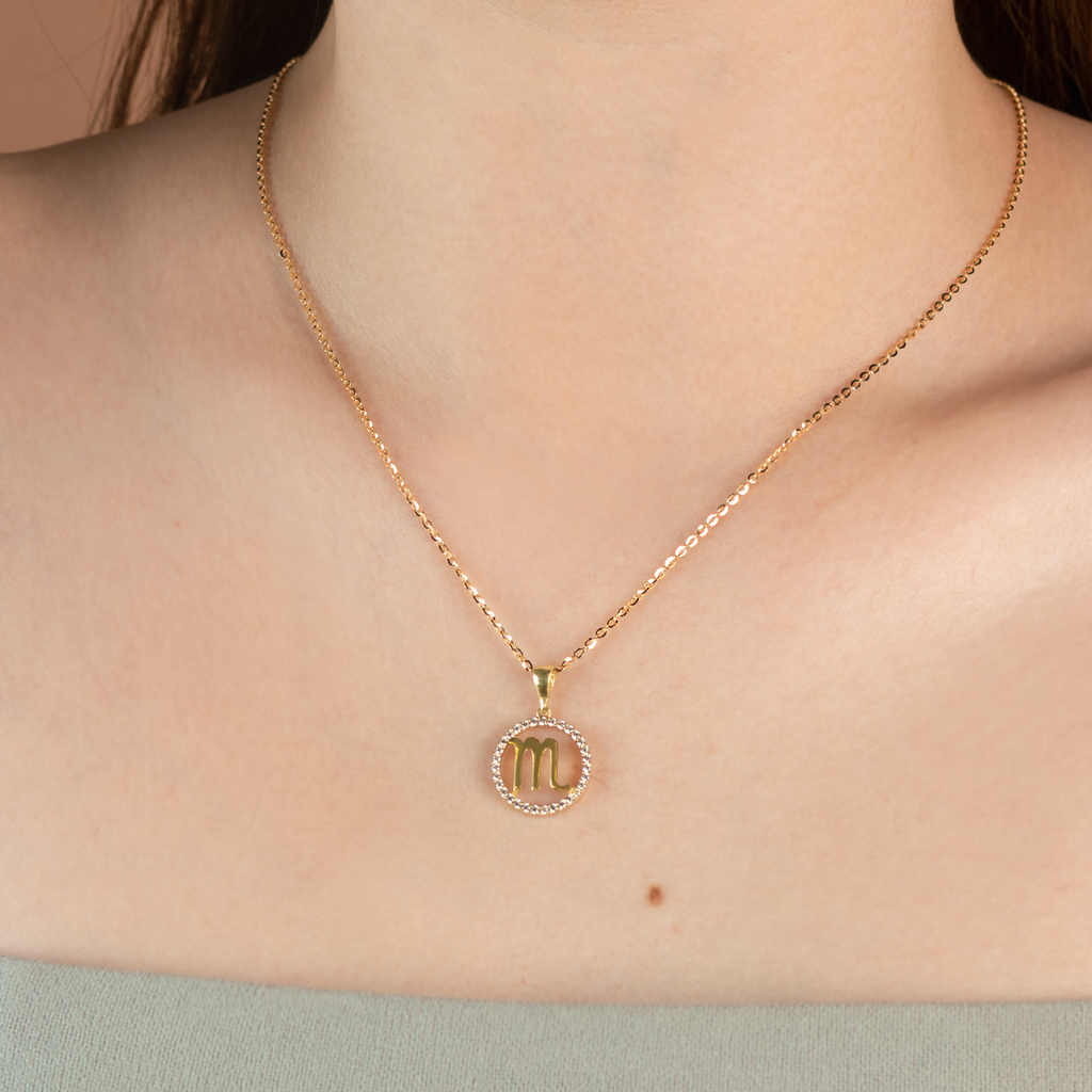 Scorpio Pendant 14k gold stacked on model neck – Foundry