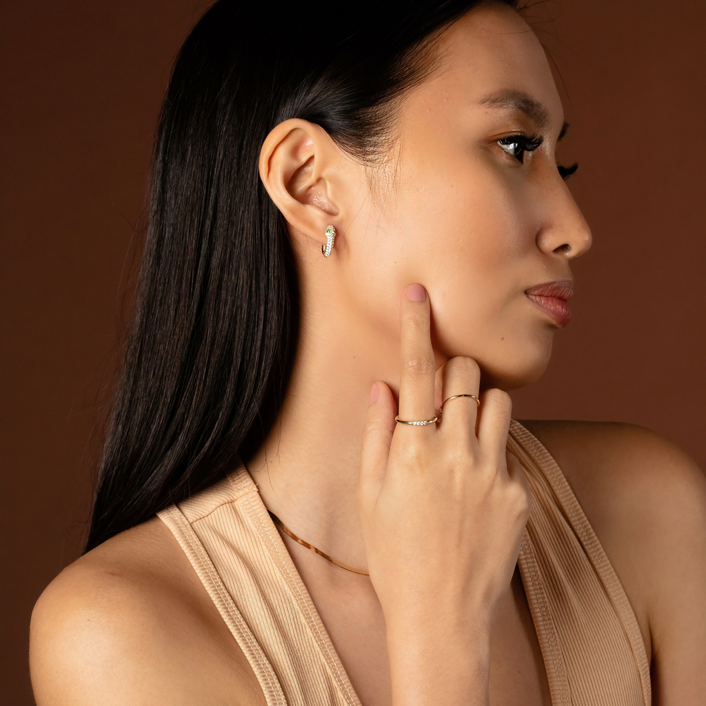Serpent Hoops 14k gold stacked on model ear – Foundry