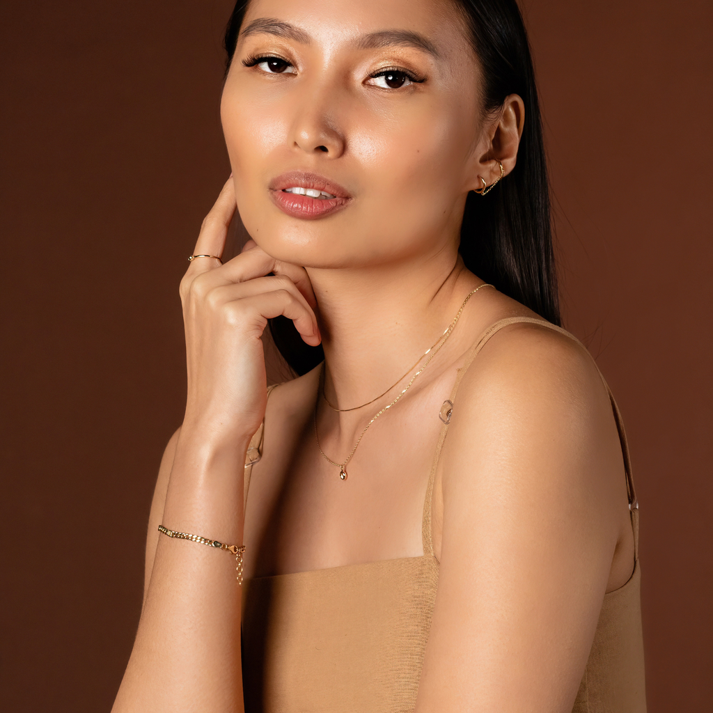Short Chain Necklace 14k gold stacked on model ear – Foundry