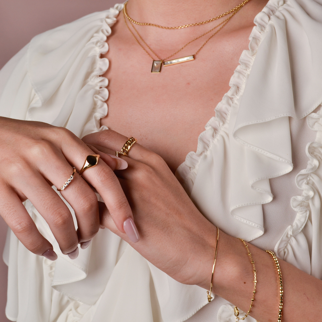 Signet Ring 14k gold stacked on model finger – Foundry