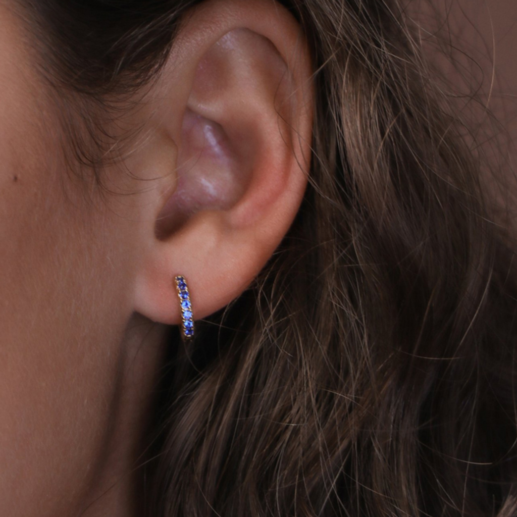 Single Gemstone Black Mini Hoop 14k gold stacked on model ear – Foundry