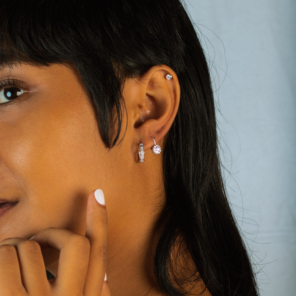 Single Mini Essential Studs 14k gold stacked on model ear – Foundry