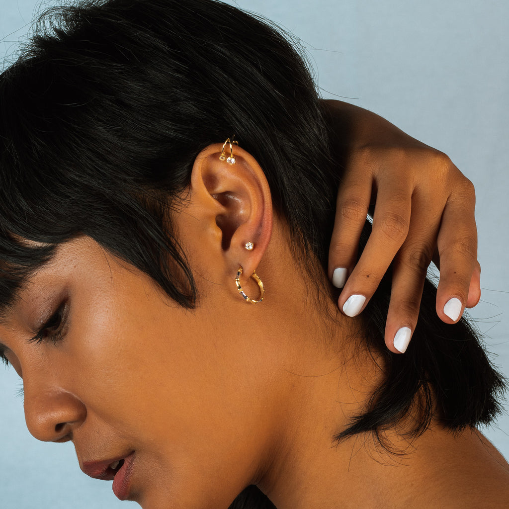 Single Round Mini Studs 18k white gold stacked on model ear – Foundry