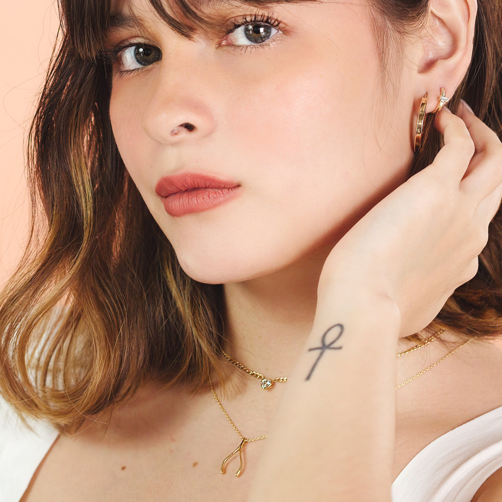 Slim Baguette Hoops 14k gold stacked on model ear – Foundry