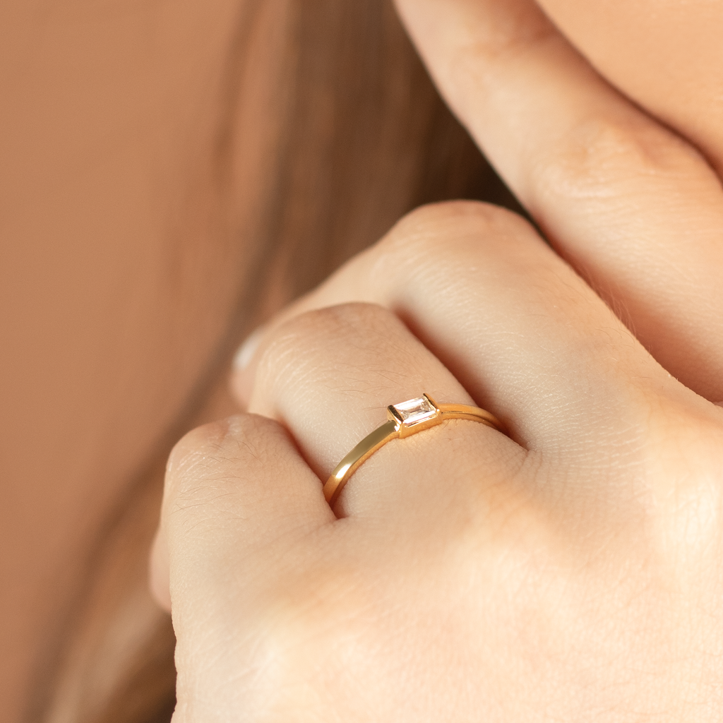 Solo Baguette Ring 14k gold stacked on model finger – Foundry