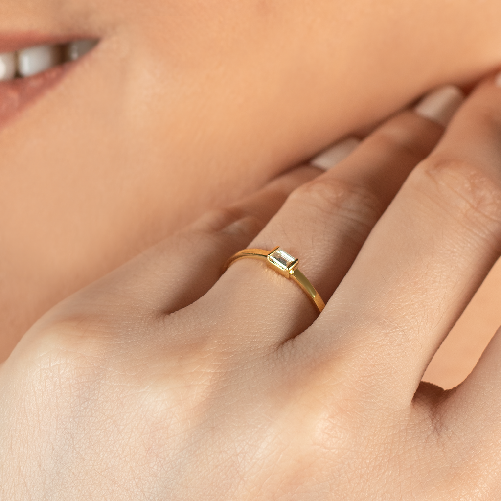 Solo Baguette Ring 14k gold stacked on model finger – Foundry