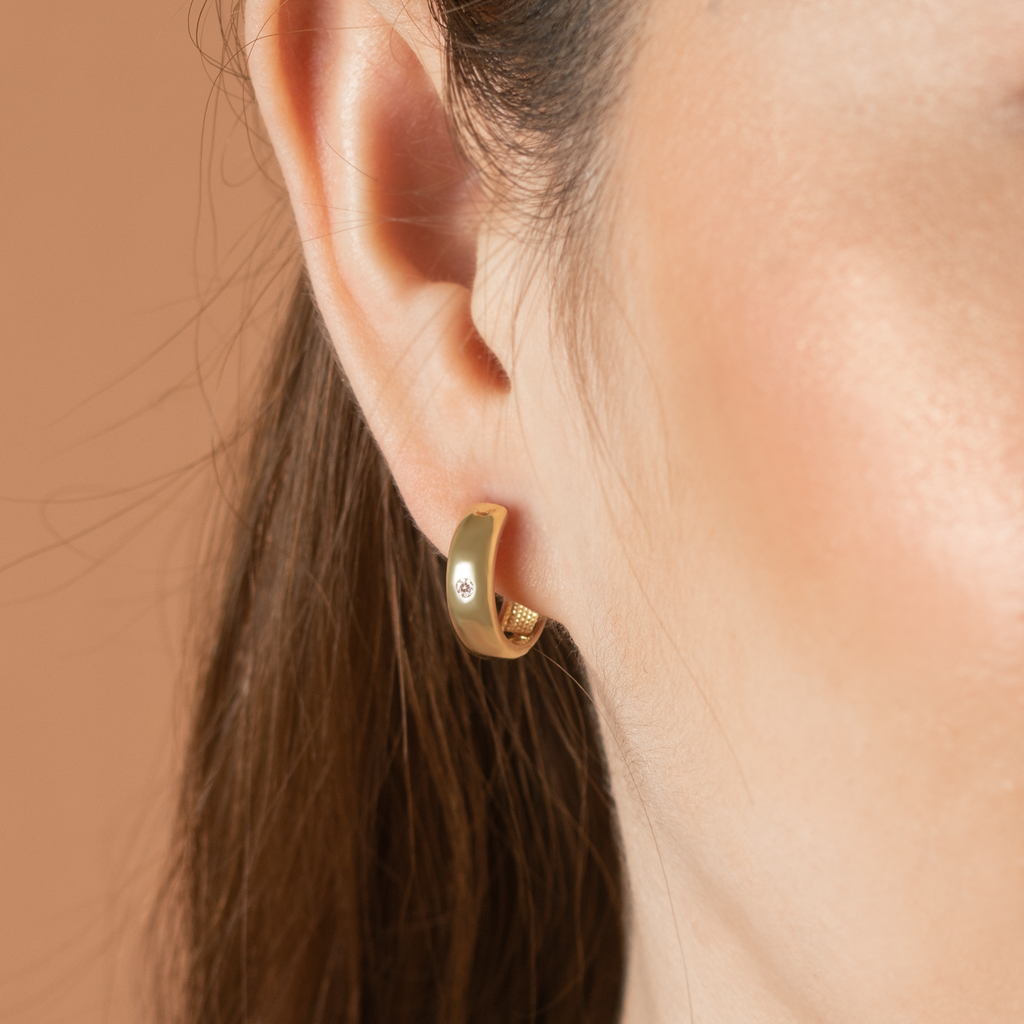 Solo Bold Hoops 14k gold stacked on model ear – Foundry