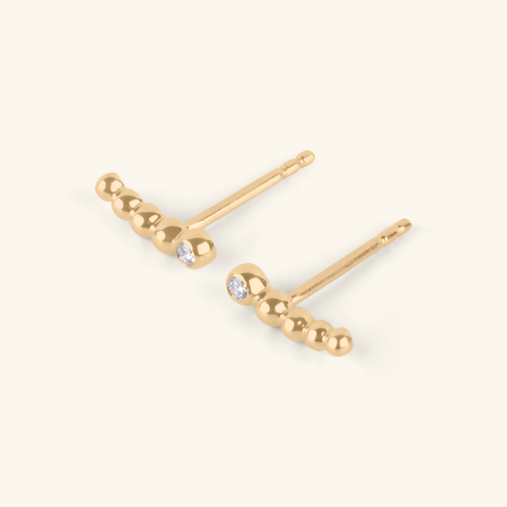 Close-up of Solo Diamond Spheres Climbers 14k gold – Foundry