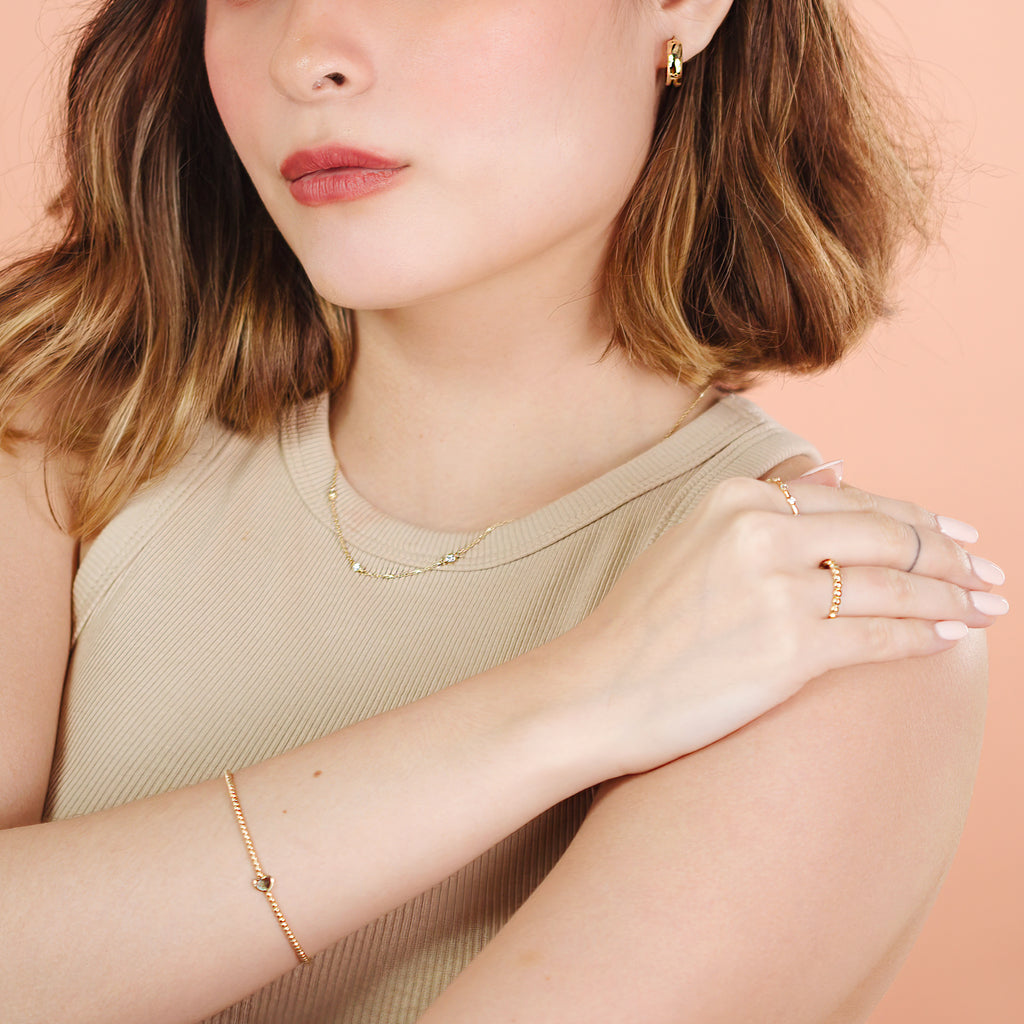 Solo Heart Spheres Bracelet 14k gold stacked on model wrist – Foundry