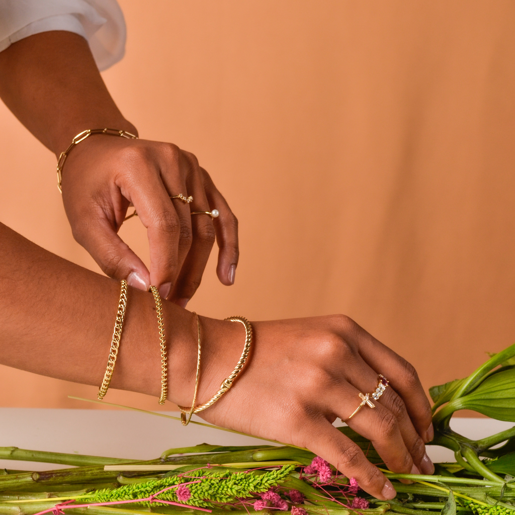 Spheres Bangle 14k gold stacked with bangles on model wrist – Foundry