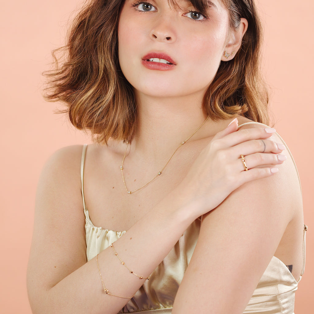 Sphere Chain Bracelet 14k gold stacked on model wrist – Foundry