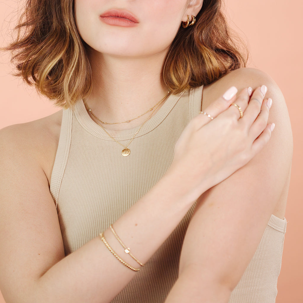 Spheres Bracelet 14k gold stacked on model wrist – Foundry