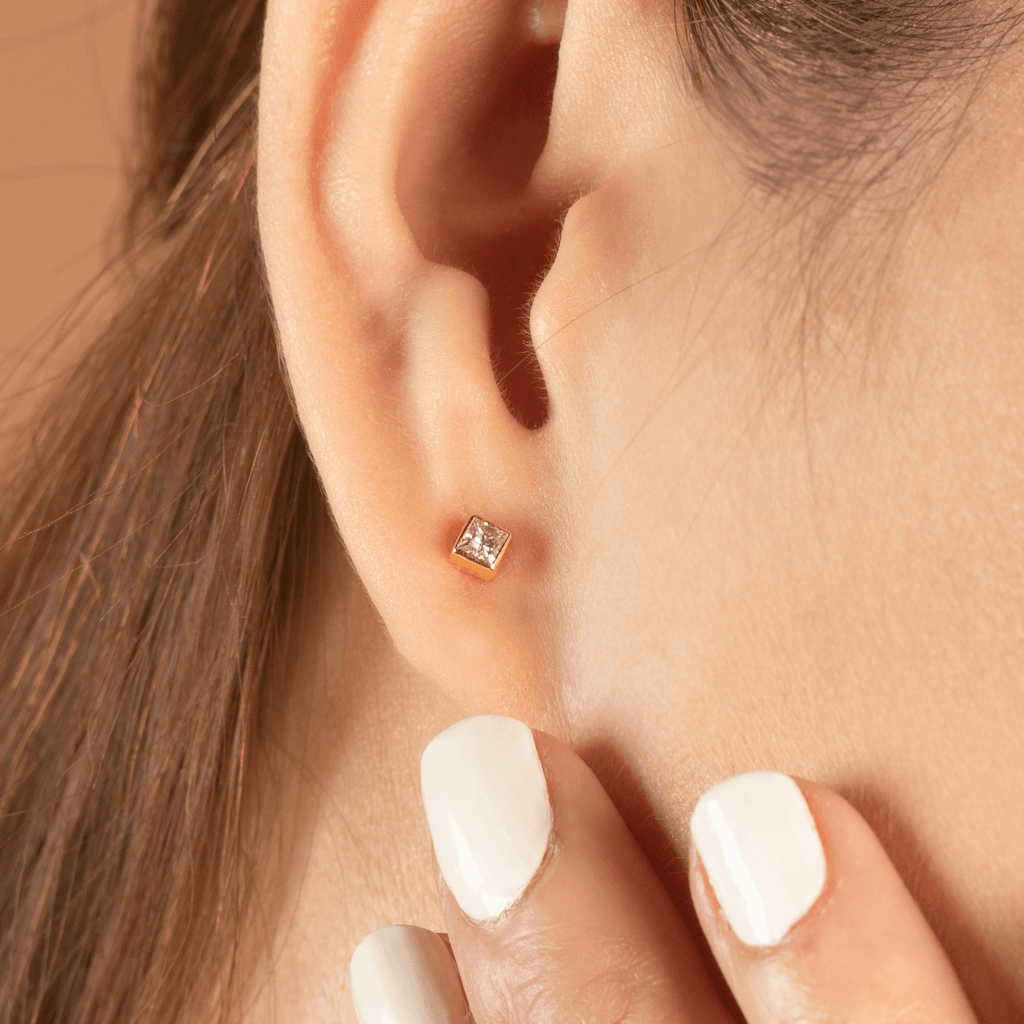 Square Diamond Studs 14k gold stacked on model ears– Foundry