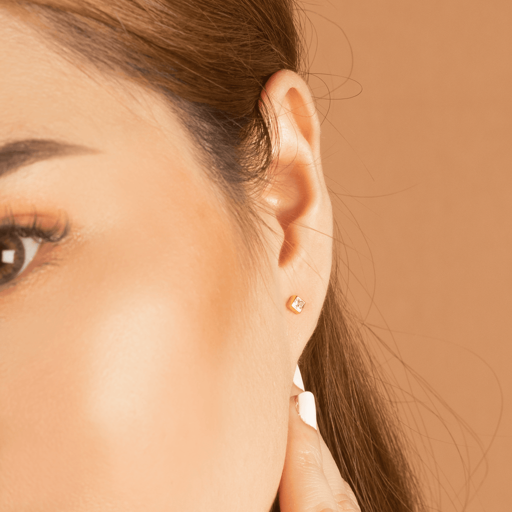 Square Diamond Studs 14k gold stacked on model ears– Foundry