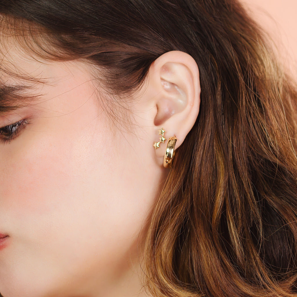 Star Cluster Studs 14k gold stacked on model ear – Foundry