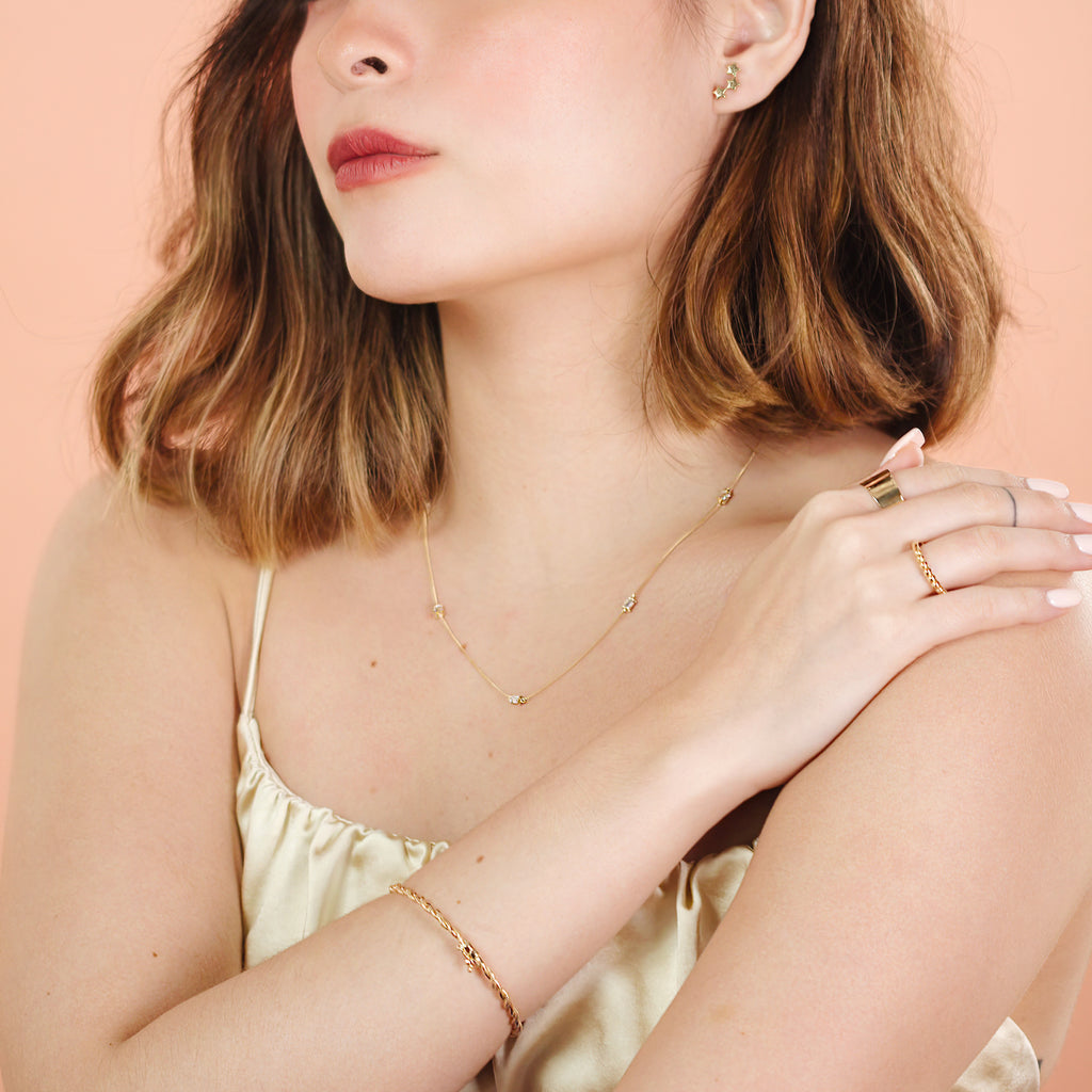 Star Cluster Studs 14k gold stacked on model ear – Foundry