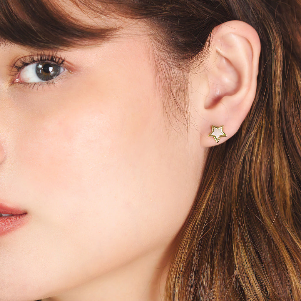 Star Mother of Pearl Studs 14k gold stacked on model ear – Foundry