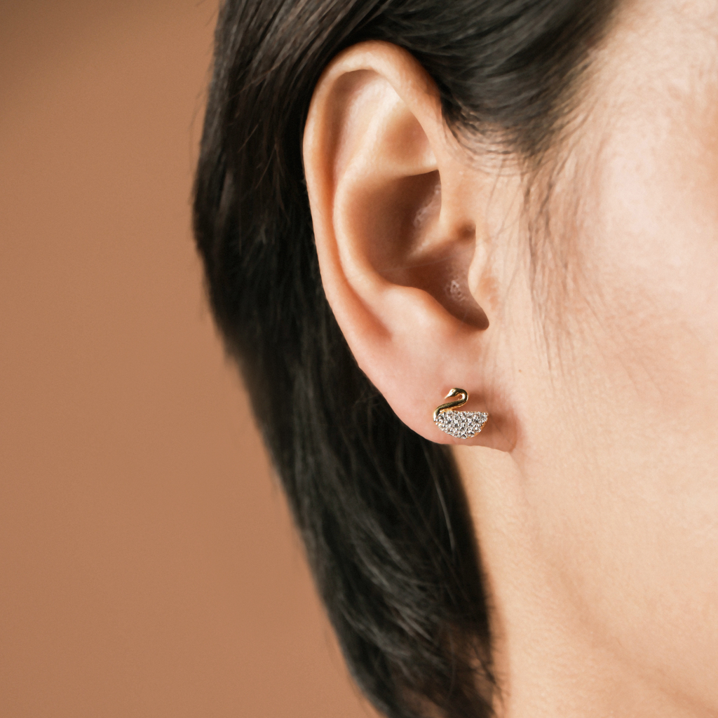 Swan Studs 18k gold stacked on model ear – Foundry