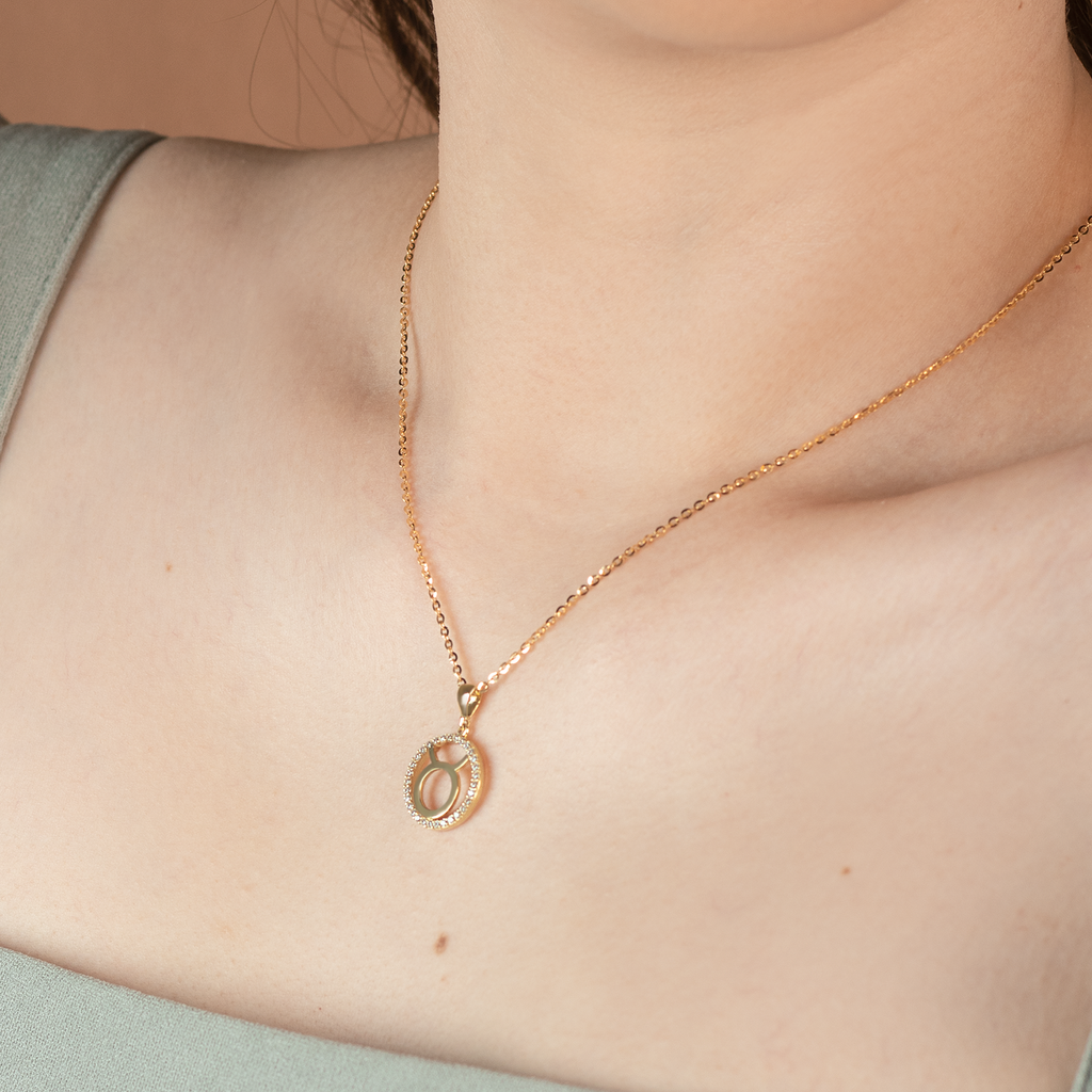 Taurus Pendant 14k gold stacked on model neck – Foundry