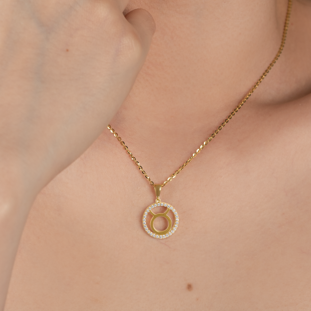 Taurus Pendant 14k gold stacked on model neck – Foundry