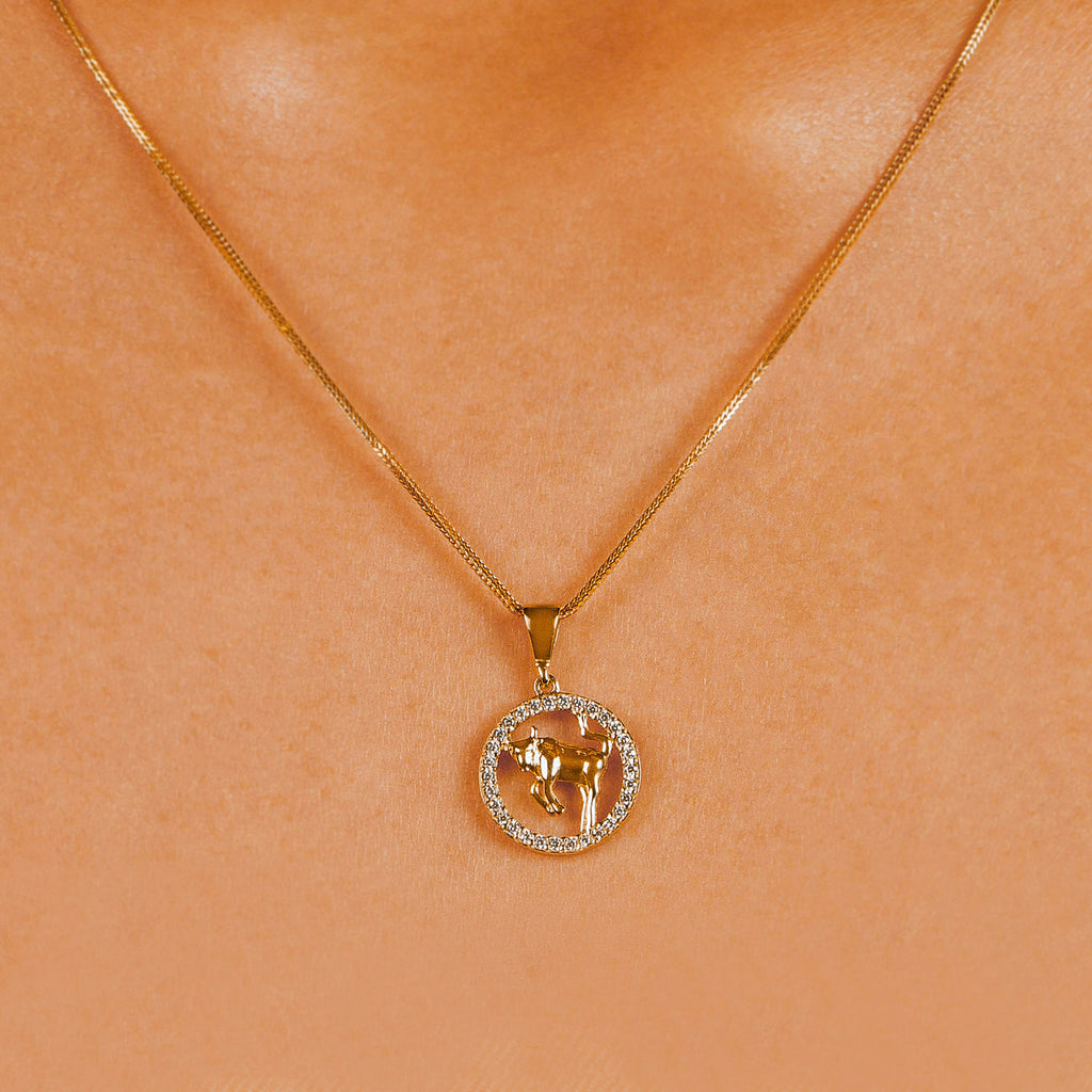 Taurus Zodiac Pendant 18k gold stacked  on model neck – Foundry