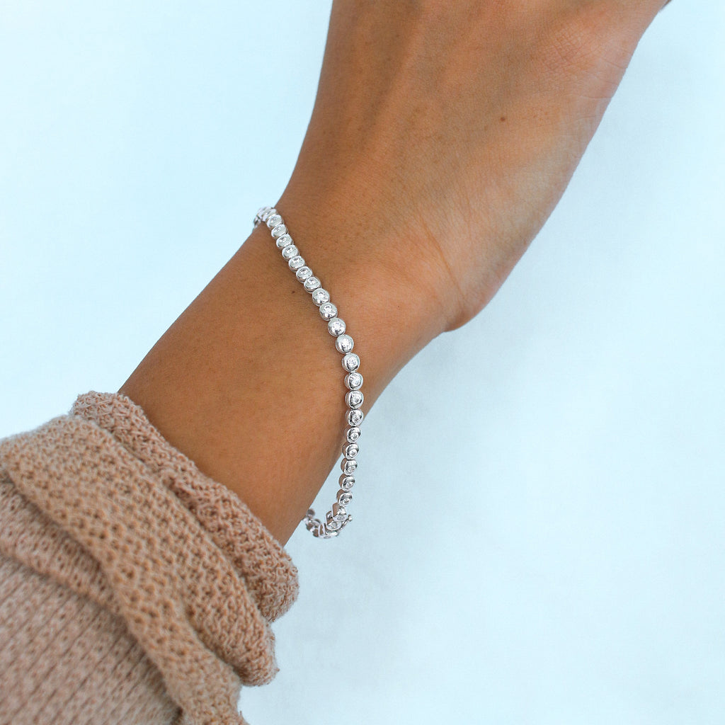 Tennis  Bracelet 18k White Gold stacked on model wrist – Foundry