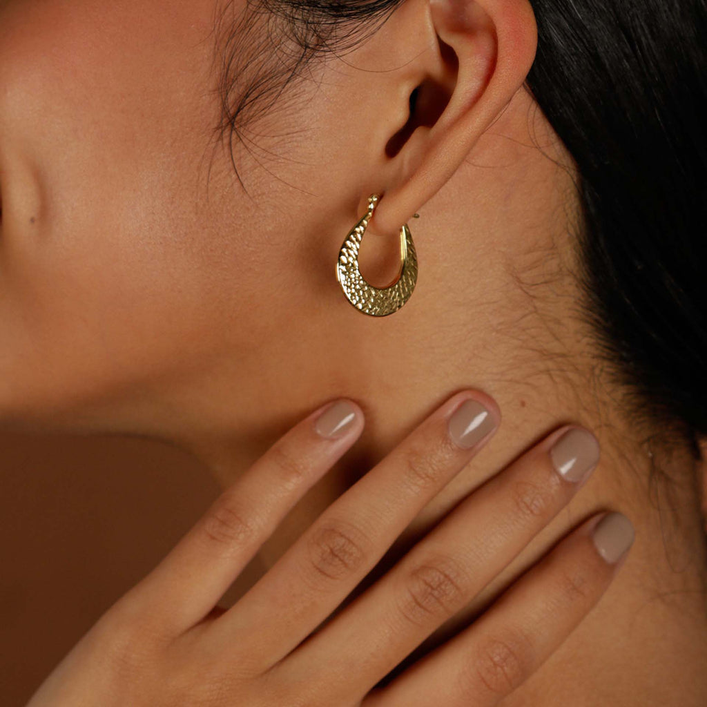 Texture Medium Hoops 18k gold stacked on model ear – Foundry