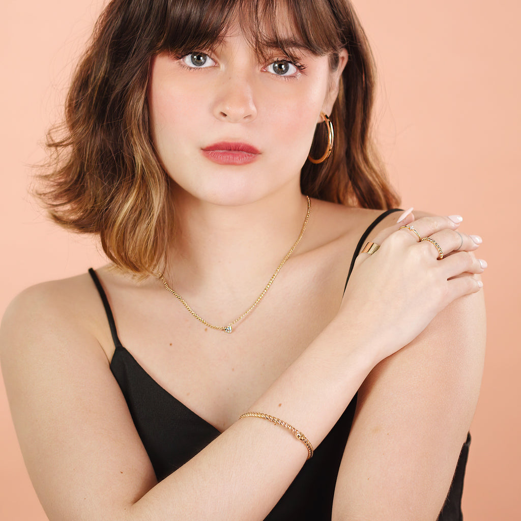 Twist Bangle 14k gold stacked with bangle on model wrist – Foundry