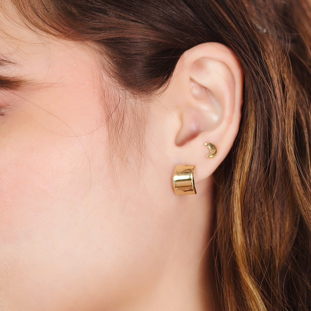 Wide Hoops 14k gold stacked on model ear – Foundry