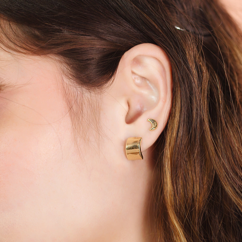 Wide Hoops 14k gold stacked on model ear – Foundry