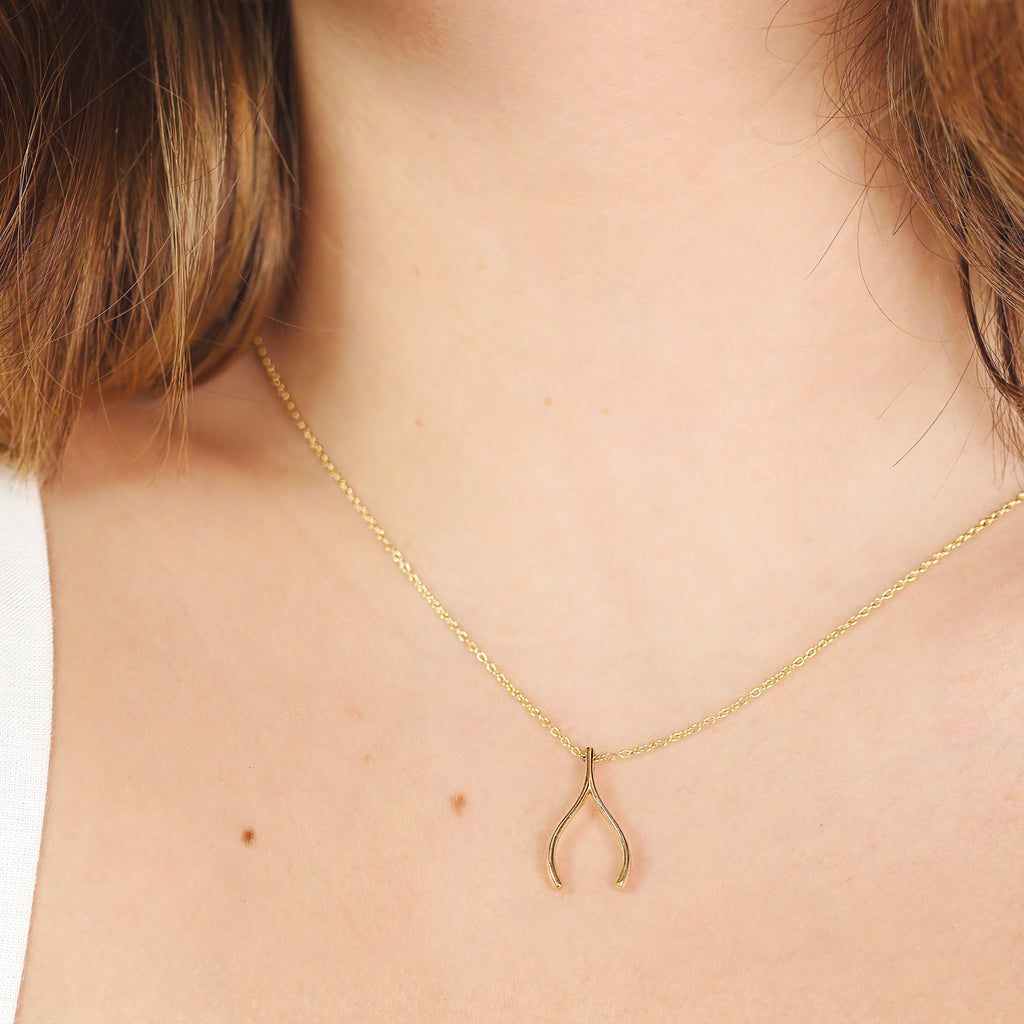 Wishbone Necklace 14k gold stacked on model neck – Foundry