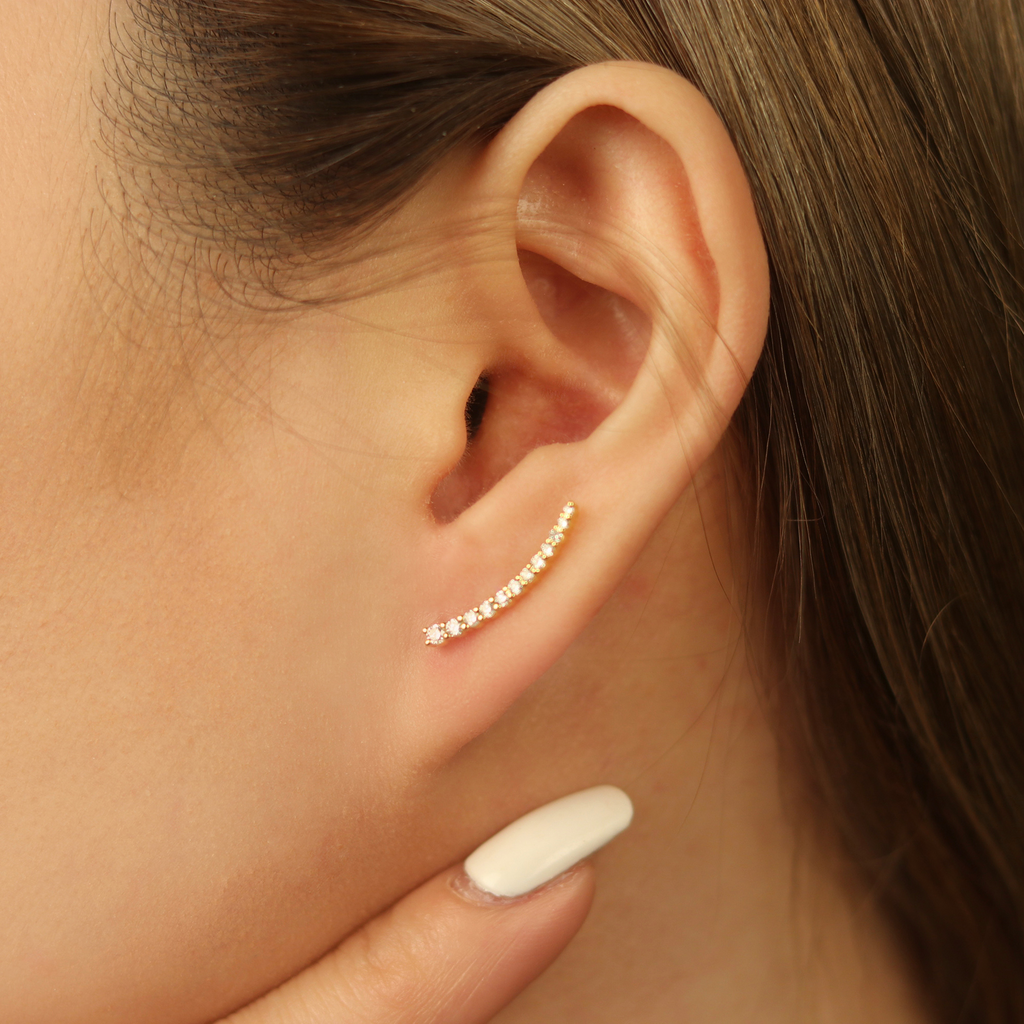 Pavé Diamond Climbers 14k gold stacked on model ear – Foundry